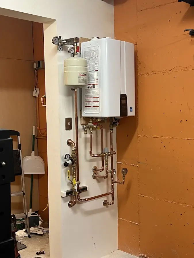 Plumbing technician inspecting water heater connections in Dana Point